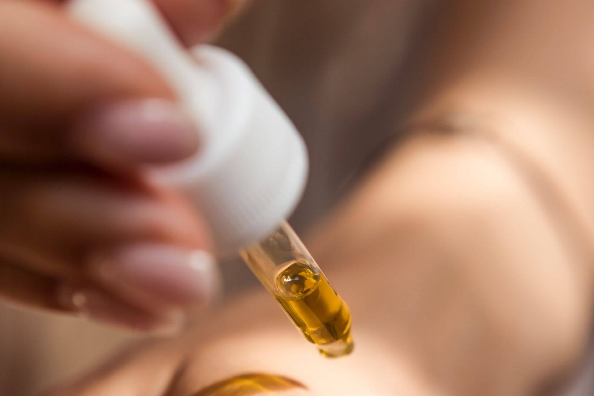 Person using a liquid dropper with Sublingual Immunotherapy. Consult primary care with Side Health.